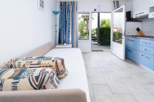 a room with two beds and a kitchen with a view at Apartment Punat 5351b in Punat