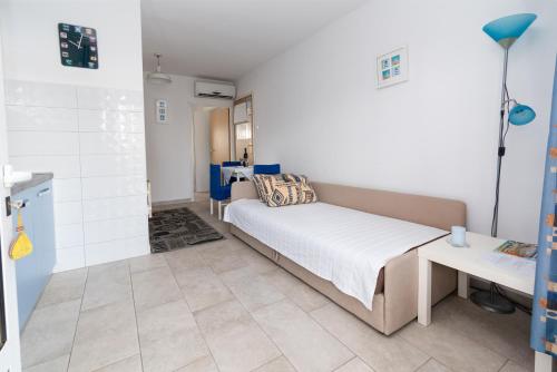 a small bedroom with a bed and a table at Apartment Punat 5351b in Punat
