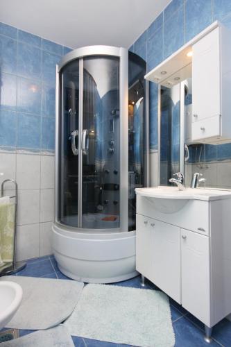 a bathroom with a shower and a sink at Apartment Punat 5350b in Punat