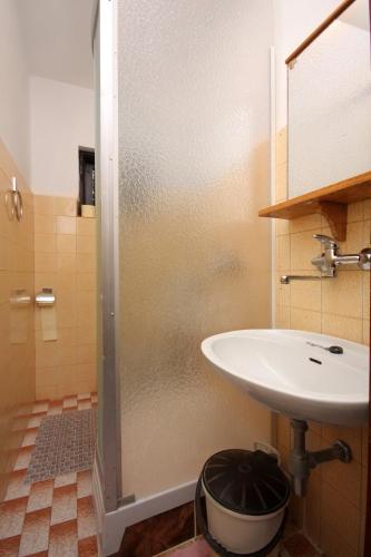 a bathroom with a sink and a shower at Apartments and rooms with parking space Punat, Krk - 5363 in Punat