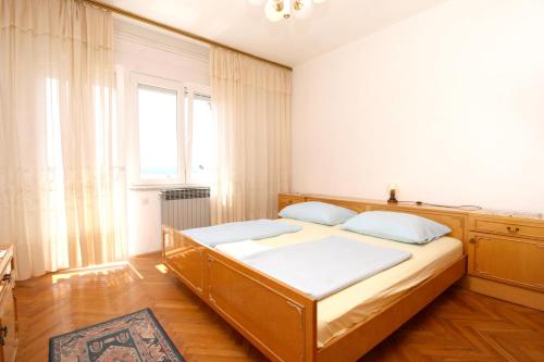 sypialnia z łóżkiem i oknem w obiekcie Apartments with a parking space Selce, Crikvenica - 5475 w mieście Selce