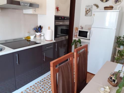 a kitchen with a sink and a white refrigerator at Apartments with WiFi Selce, Crikvenica - 5498 in Selce