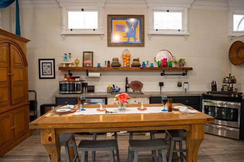 a kitchen with a large wooden table and chairs at Chateau Royale, Pet Friendly, On Bayou, Downtown! in New Iberia