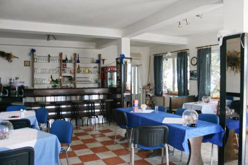 a restaurant with blue tables and blue chairs at Apartments and rooms with parking space Stara Baska, Krk - 5447 in Stara Baška