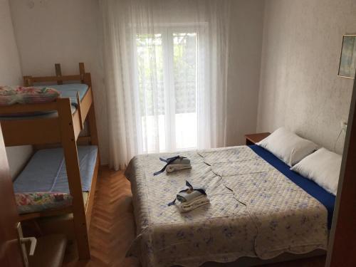 a small bedroom with two beds and a window at Apartments with a parking space Smrika, Kraljevica - 5338 in Šmrika