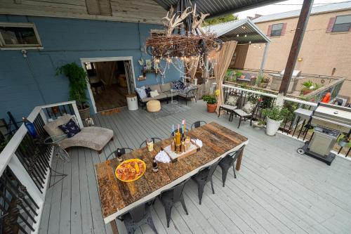 an overhead view of a patio with a table with pizza at Chateau Royale, Pet Friendly, On Bayou, Downtown! in New Iberia