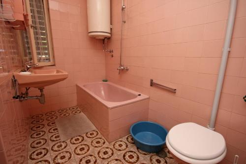 a bathroom with a toilet and a sink and a tub at Apartments with a parking space Selce, Crikvenica - 5531 in Selce