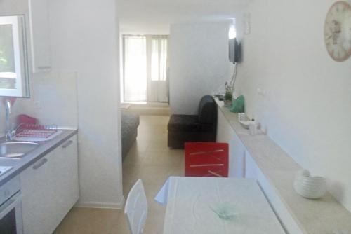 a kitchen and a living room with a table at Apartment Selce 5531b in Selce