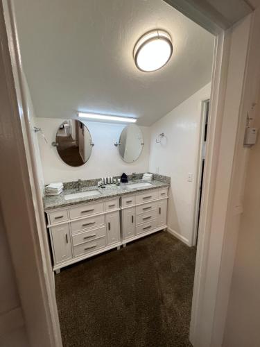 a bathroom with a sink and two mirrors at June Lake Villager in June Lake