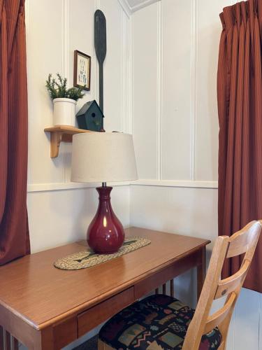 a table with a lamp and a chair on it at June Lake Villager in June Lake