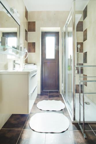 a bathroom with a sink and a shower and a door at Apartments with a parking space Malinska (Krk) - 5456 in Vantačići
