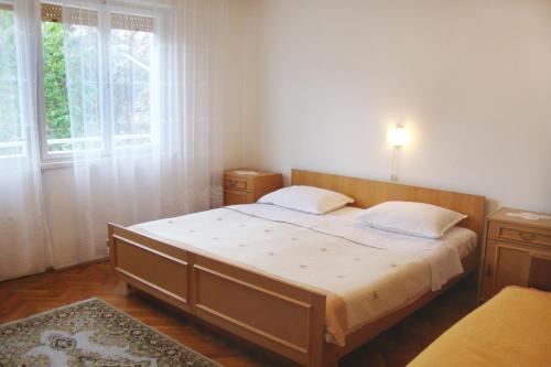a bedroom with a bed and a large window at Apartments with a parking space Baska, Krk - 5407 in Baška