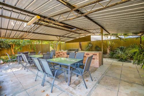 a patio with a table and chairs under a pergola at Viewhill Holiday Units - Bright in Bright