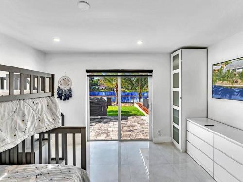 a bedroom with a bed and a sliding glass door at 5-star Lakefront Oasis In Hollywood-Hard rock casino in Fort Lauderdale