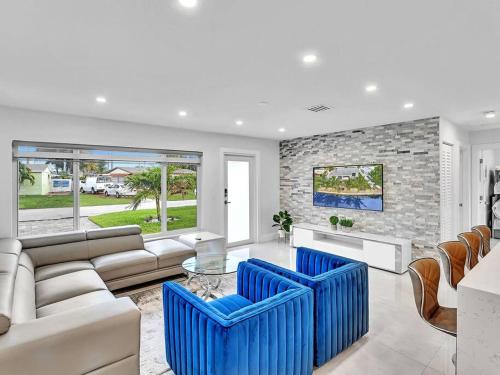 a living room with a couch and blue chairs at 5-star Lakefront Oasis In Hollywood-Hard rock casino in Fort Lauderdale