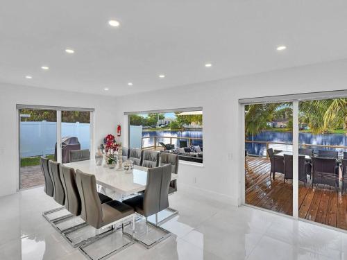 a white dining room with a table and chairs at 5-star Lakefront Oasis In Hollywood-Hard rock casino in Fort Lauderdale