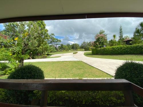 a view of a park with a bench and a walkway at Pruksa View Homestay in Ban Phu Hi