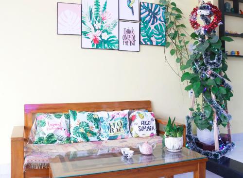 a living room with a couch and a table at PHỐ CHỢ ĐÊM Villa - Near Hoi An Old Town 200m in Hoi An
