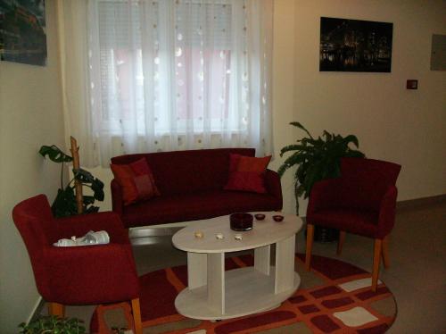 a living room with a couch and two chairs and a table at B&B Zmajevo Gnezdo 021 in Sremska Kamenica