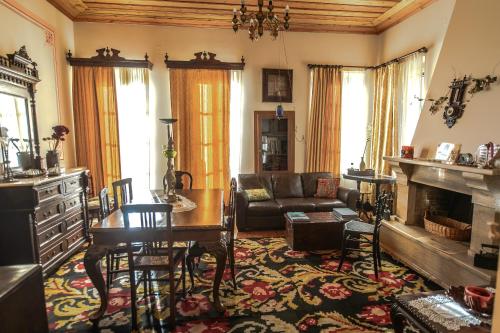 a living room with a couch and a table at Gerofotis Traditional Guesthouse est 1892 - Close to Aigio, Akoli, Selianitika in Lákka