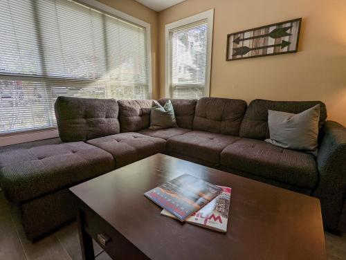a living room with a couch and a coffee table at Steps to All New Gondola, Sleeps 4 with Free Parking in Whistler