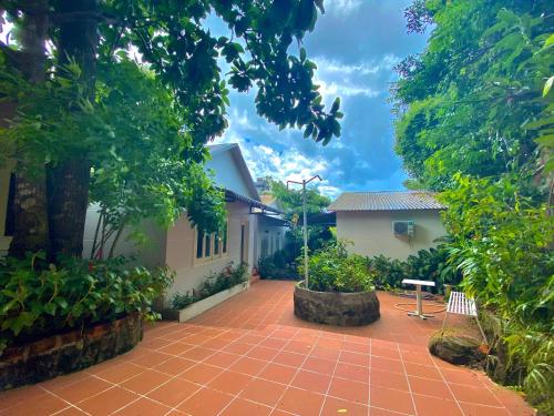 a courtyard of a house with a table and trees at Ngoc Hanh Bungalow Phu Quoc in Phu Quoc