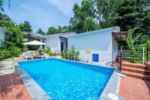 a swimming pool in the backyard of a house at Ngoc Hanh Bungalow Phu Quoc in Phu Quoc