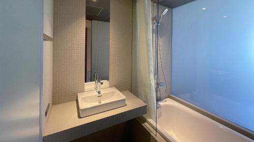 a bathroom with a sink and a bath tub at kamakura seizan in Kamakura
