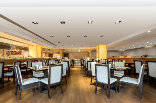 a dining room with tables and chairs at Millennium Hotel Wuxi in Wuxi