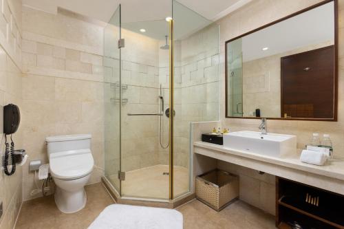 a bathroom with a shower and a toilet and a sink at Millennium Hotel Wuxi in Wuxi