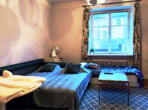 a bedroom with two beds and a window at Quiet Central Room in Stockholm