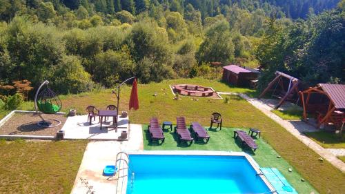 an aerial view of a backyard with a pool and a playground at SONATA Чан біля річки in Skole