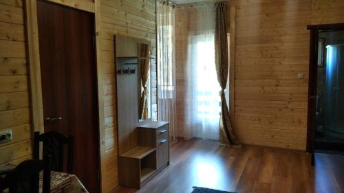 a room with wooden walls and a wooden floor and a door at SONATA Чан біля річки in Skole