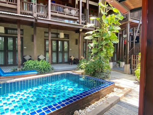a swimming pool in the courtyard of a building at Banthai Village in Chiang Mai
