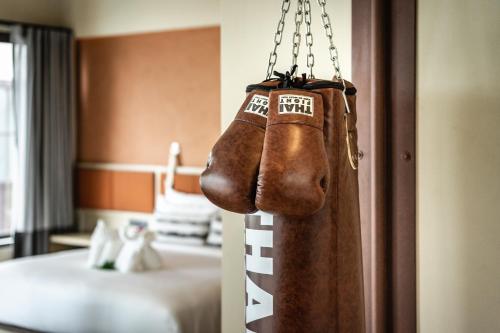 a pair of boxing gloves hanging in a hotel room at Thai Fight Hotel in Lamai