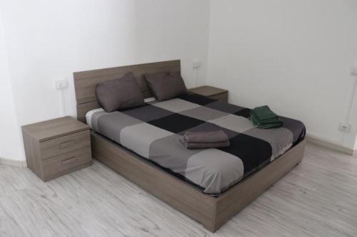a bedroom with a large bed with a wooden frame at Appartamento Centro Storico Porlezza in Porlezza