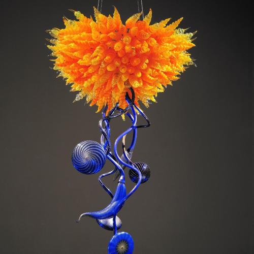 a blue glass vase with a flower in it at Hotel Royal Classic Osaka in Osaka