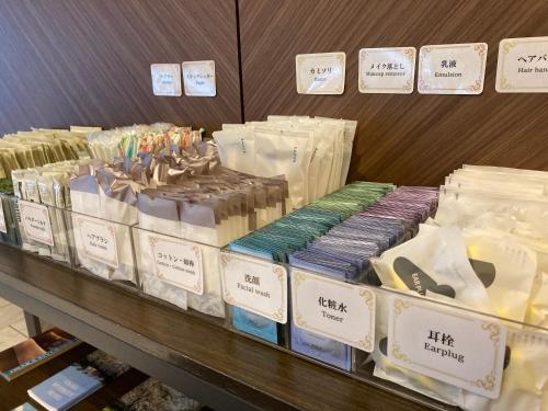 a display of different types of hair products on a shelf at Osaka Riverside Hotel in Osaka
