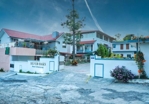 a building with a sign that reads supercross hotel apartments at SS Silver Oaks Resort in Yercaud