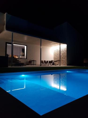 a house with a swimming pool at night at Casa Maria Dolors con piscina y jardin privado in Puig-Gros