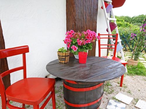a wooden table with flowers on top of a barrel at Krka Fairytale Little Castle in Skradin
