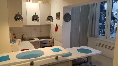 a kitchen with a table and a counter top at Apartmani Šišava apt "HARMONY" Vlašić in Vlasic