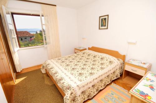 a small bedroom with a bed and a window at Apartments with a parking space Bol, Brac - 5605 in Bol