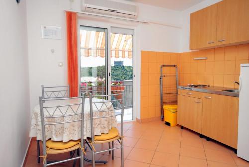 - une cuisine avec une table et des chaises dans la chambre dans l'établissement Apartments and rooms with parking space Senj - 5569, à Senj