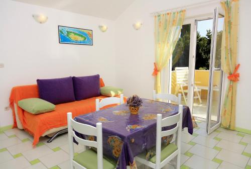 a living room with a table and a couch at Apartments with a parking space Bol, Brac - 5642 in Bol