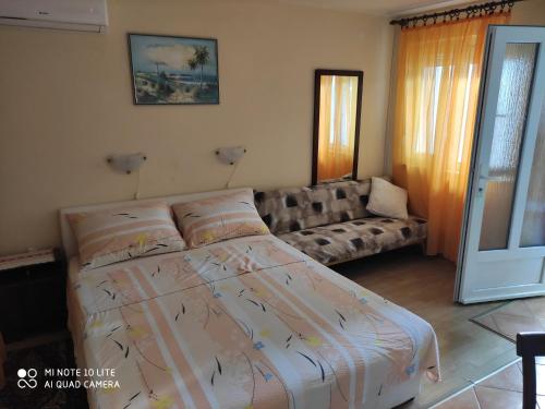 a bedroom with a bed and a couch at Apartments by the sea Selce, Crikvenica - 5550 in Selce