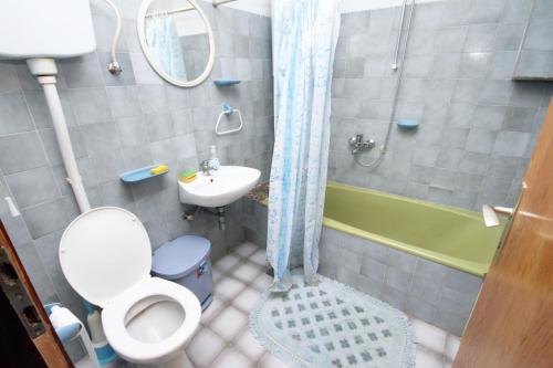 a bathroom with a toilet and a sink and a shower at Apartments by the sea Sumartin, Brac - 5615 in Sumartin