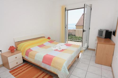 a bedroom with a bed and a view of the ocean at Apartments with a parking space Bol, Brac - 5641 in Bol