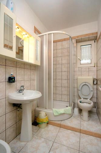 a bathroom with a toilet and a sink and a shower at Apartments with parking space Crikvenica - 5553 in Crikvenica