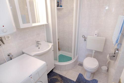 a bathroom with a toilet and a sink and a shower at Apartments by the sea Postira, Brac - 5660 in Postira